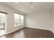 Bright living room featuring wood floors, neutral walls, and natural light from a sliding glass door and two windows at 7247 Barker St, Carmel, IN 46033