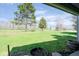 The backyard offers a large lawn and mature trees, creating a serene environment, as seen from covered porch at 797 Crossbridge Ct, Avon, IN 46123