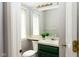 Well-lit half bathroom featuring a vanity with a green cabinet and large mirror at 797 Crossbridge Ct, Avon, IN 46123