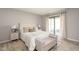 Beautifully styled bedroom with neutral colors and a sliding glass door to the patio at 797 Crossbridge Ct, Avon, IN 46123
