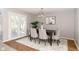 Dining area with table set for six, a sliding glass door, and decorative chandelier at 797 Crossbridge Ct, Avon, IN 46123