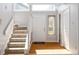 Bright foyer with hardwood floors, a staircase, and a window above the front door at 797 Crossbridge Ct, Avon, IN 46123
