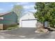 View of detached two-car garage with white siding and an asphalt driveway, located next to the house and fenced yard at 797 Crossbridge Ct, Avon, IN 46123