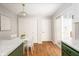 Bright eat-in kitchen boasts a white table, green accent cabinets, and lovely laminate floors at 797 Crossbridge Ct, Avon, IN 46123