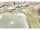 Expansive aerial shot overlooking the water feature and multiple homes in a suburban neighborhood at 836 Grassy Branch Dr, Indianapolis, IN 46239