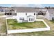 Exterior shot of the house showcasing a well-maintained yard, privacy fence, and back deck at 836 Grassy Branch Dr, Indianapolis, IN 46239