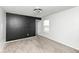 Bedroom with carpet, window, and accent wall featuring a modern light fixture at 836 Grassy Branch Dr, Indianapolis, IN 46239