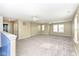 Large bonus room with neutral carpet, natural lighting, and modern ceiling fans at 836 Grassy Branch Dr, Indianapolis, IN 46239