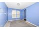 Cozy dining room featuring a blue accent wall, neutral carpet, and two windows with natural light at 836 Grassy Branch Dr, Indianapolis, IN 46239