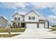 Inviting two-story home with brick accents, three-car garage, basketball hoop, and a manicured lawn at 836 Grassy Branch Dr, Indianapolis, IN 46239