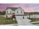 Charming home featuring a three-car garage, a basketball hoop, and a picturesque pond view at sunset at 836 Grassy Branch Dr, Indianapolis, IN 46239