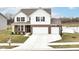 Charming home featuring a three-car garage, a basketball hoop, and a picturesque pond view in the back at 836 Grassy Branch Dr, Indianapolis, IN 46239