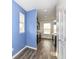 Hallway showcasing hardwood floors, opening to a kitchen with dark cabinetry and stainless steel appliances at 836 Grassy Branch Dr, Indianapolis, IN 46239