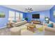 Bright living room featuring a ceiling fan, TV, modern furniture, and natural light from large windows at 836 Grassy Branch Dr, Indianapolis, IN 46239