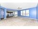 Open-concept living room boasts neutral carpet and blue walls, connecting to a modern kitchen with stainless appliances at 836 Grassy Branch Dr, Indianapolis, IN 46239