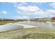 Community pond with a water feature, surrounded by green space and residential homes at 836 Grassy Branch Dr, Indianapolis, IN 46239