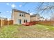 Home exterior featuring a backyard and red deck with wood fence at 8808 Hosta Way, Indianapolis, IN 46113