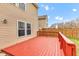 Home exterior featuring a sunny red deck and backyard area at 8808 Hosta Way, Indianapolis, IN 46113