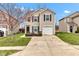 Charming two-story home featuring black shutters, a one-car garage, and a well-maintained front lawn at 8808 Hosta Way, Indianapolis, IN 46113