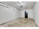 Clean, empty garage with concrete floor and side entry door at 8808 Hosta Way, Indianapolis, IN 46113