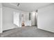 Bright hallway featuring neutral walls and carpeting, leading to a bathroom and stairway at 8808 Hosta Way, Indianapolis, IN 46113