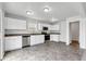 Bright kitchen with stainless steel appliances, white cabinets, and stone countertops at 8808 Hosta Way, Indianapolis, IN 46113