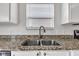 Close-up of a stainless steel sink and granite countertops in the kitchen at 8808 Hosta Way, Indianapolis, IN 46113