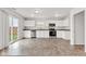 Bright kitchen featuring white cabinets, stainless steel appliances, and granite countertops at 8808 Hosta Way, Indianapolis, IN 46113