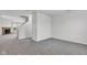 Spacious living room featuring a brick fireplace, stairs, and neutral carpet flooring at 8808 Hosta Way, Indianapolis, IN 46113