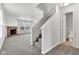Living room featuring a fireplace, stairs, carpet, and a partial view of the bathroom at 8808 Hosta Way, Indianapolis, IN 46113