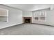 Spacious living room area with multiple windows, a fireplace, and neutral colored carpet at 8808 Hosta Way, Indianapolis, IN 46113
