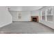 Open living area with fireplace, neutral walls, and carpet at 8808 Hosta Way, Indianapolis, IN 46113