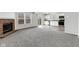 Open floor plan with a fireplace, windows, and a view into the kitchen and dining areas at 8808 Hosta Way, Indianapolis, IN 46113