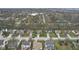 Aerial view of a neighborhood showcasing well-manicured lawns, mature trees, and a serene pond at 894 Woodgate Ln, Greenwood, IN 46143