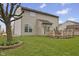 Backyard with a patio, lush green grass, a large tree, and the rear of a two-story home at 894 Woodgate Ln, Greenwood, IN 46143