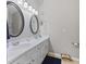 Bathroom showcasing a double sink vanity with oval mirrors and modern lighting fixtures at 894 Woodgate Ln, Greenwood, IN 46143