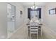 Bright dining room showcasing a dining table, white chairs, chandelier, and a large window at 894 Woodgate Ln, Greenwood, IN 46143
