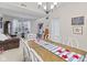 Cozy dining room displaying a wooden dining table with chairs, chandelier, and patriotic decor at 894 Woodgate Ln, Greenwood, IN 46143