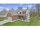 Attractive two-story home boasts a well-maintained lawn, brick accents, and a welcoming front porch at 894 Woodgate Ln, Greenwood, IN 46143