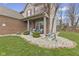 Close up view of the home's inviting front porch and meticulously landscaped front yard at 894 Woodgate Ln, Greenwood, IN 46143