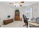 Inviting home office with a rolling chair, desk, and a window allowing natural light to fill the space at 894 Woodgate Ln, Greenwood, IN 46143