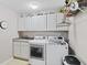 Bright laundry room features a washer, dryer, storage cabinets, gray counters, and a neutral color scheme at 894 Woodgate Ln, Greenwood, IN 46143