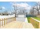 Backyard featuring a deck with a detached garage, perfect for outdoor entertaining and additional storage at 902 N Anderson St, Elwood, IN 46036