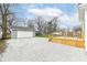 View of detached garage, new wood deck and gravel parking area at 902 N Anderson St, Elwood, IN 46036
