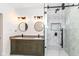 Modern bathroom featuring double sinks, elegant lighting, and a glass-enclosed shower, designed for contemporary living at 902 N Anderson St, Elwood, IN 46036
