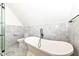 Bright bathroom features a standalone soaking tub and separate glass-enclosed shower at 902 N Anderson St, Elwood, IN 46036