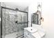 Modern bathroom features a glass-enclosed shower with stylish marble tile and contemporary vanity lighting at 902 N Anderson St, Elwood, IN 46036