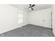 Cozy bedroom with a modern ceiling fan, plush carpet, and ample natural light, perfect for relaxation at 902 N Anderson St, Elwood, IN 46036