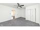 Bright bedroom features neutral carpet, ceiling fan, double door closet, and plenty of space creating a comfortable environment at 902 N Anderson St, Elwood, IN 46036