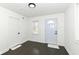 Bright entryway featuring a light blue front door, dark hardwood floors, and white walls, creating a welcoming ambiance at 902 N Anderson St, Elwood, IN 46036
